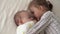 Childhood, infancy, family, sleep, rest concept - close up of two joyful happy children, newborn baby and 3-4 year old