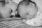 Childhood, infancy, family, sleep, rest, love concepts .black and white close up view of two children, newborn baby and