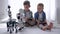 Childhood, little boys control robots using mobile phones playing together at weekend at home