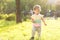 Childhood, nature, summer, parks and outdoors concept - portrait of cute blond-haired little boy in striped multi