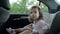 Childhood road trip and people concept. Little girl sitting in baby car seat while the car is driving