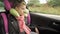 Childhood road trip and people concept - teen girl sleeping in baby car seat with travel pillow