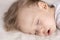 Childhood, sleep, rest, family, lifestyle concept - close-up portrait of a cute little boy of 2 years old in a white