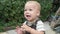 Childhood, toddler, motherhood, summer. Happy smiling Baby Boy Kid playing outside in garden Playground. Funny Child