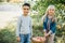 Children with Apple in the Apple Orchard. Child Eating Organic Apple in the Orchard. Harvest Concept. Garden, Toddler eating