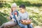 Children with Apple in Orchard. Harvest Concept