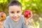 Children with Apple in Orchard. Harvest Concept