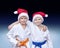 Children athletes in caps of Santa Claus on a gradient background