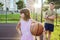 Children with a ball on an open basketball court. Healthy lifestyle and sport concepts