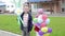 Children with balloons in the form of flowers.