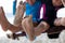 Children bare feet with sand while they playing on a swings together at the beach near the sea