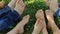 Children with bare feet sitting on green grass, grain and noise