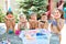 Children in bathing suits with watermelons at their birthday in
