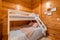 Children bedroom with bunk bed and wooden walls. Cozy and comfortable cottage interior.