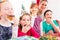 Children at birthday party with muffins and cake