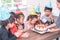 Children is blowing birthday cake in birthday party singing happy birthday