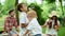 Children blowing bubbles outdoors. Parents spending time with kids in park