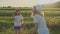 Children blowing soap bubbles, two girls playing in nature