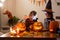 Children, boy brothers, playing with carved pumpkin at home on Halloween