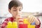 Children boy playing in terrace building blocks with face mask protection