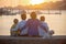 Children, boys, brothers, enjoying sunset over river with their pet maltese dog and mom, boats, sun, river