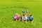 Children boys and girl lie on the grass on green meadow in the park. Summer concept, children`s games in the fresh air.