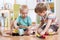 Children boys playing railroad together in playroom