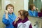 Children brush their teeth morning in the bathroom , dressed in robes