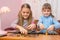 Children build towers of coins