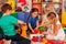 Children building blocks in kindergarten. Group kids playing toy floor .