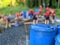 Children building a raft out of blue barrels