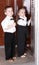 Children in business suit in elevator.