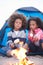 Children Camping On Beach And Toasting Marshmallows