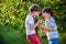 Children with a carrot in the garden. Two boys with vegetables in farm