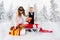 Children carry a heap of gifts on a sledge.