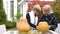 Children carving pumpkin Jack for Halloween party, boy helping girl with crafts