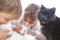 Children and cat drinking milk