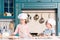 children in chef hats and aprons cooking together