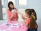 Children choose a card from their mother playing a board game