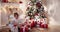 Children with Christmas presents under the Christmas tree.