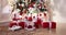 Children with Christmas presents under the Christmas tree.