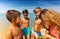 Children circle to check found on beach seashell