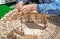 Children collect a wooden designer project of a new stadium for the World Cup.