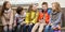 Children communicate sitting on bench in yard