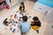 Children connecting jigsaw puzzle pieces in a kids room on floor at home. Fun family activity leisure