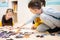 Children connecting jigsaw puzzle pieces in a kids room on floor at home. Fun family activity leisure