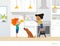 Children cooking food in kitchen. Red head boy holding pitcher with drink, girl in apron standing by stove and cute pet dog. Home