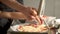 Children cooks pizza. Boy and girl having fun with father. Prepering ingredients for pizza.