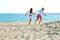 Children couple running on beach.