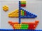 Children create sailing ship using mosaic